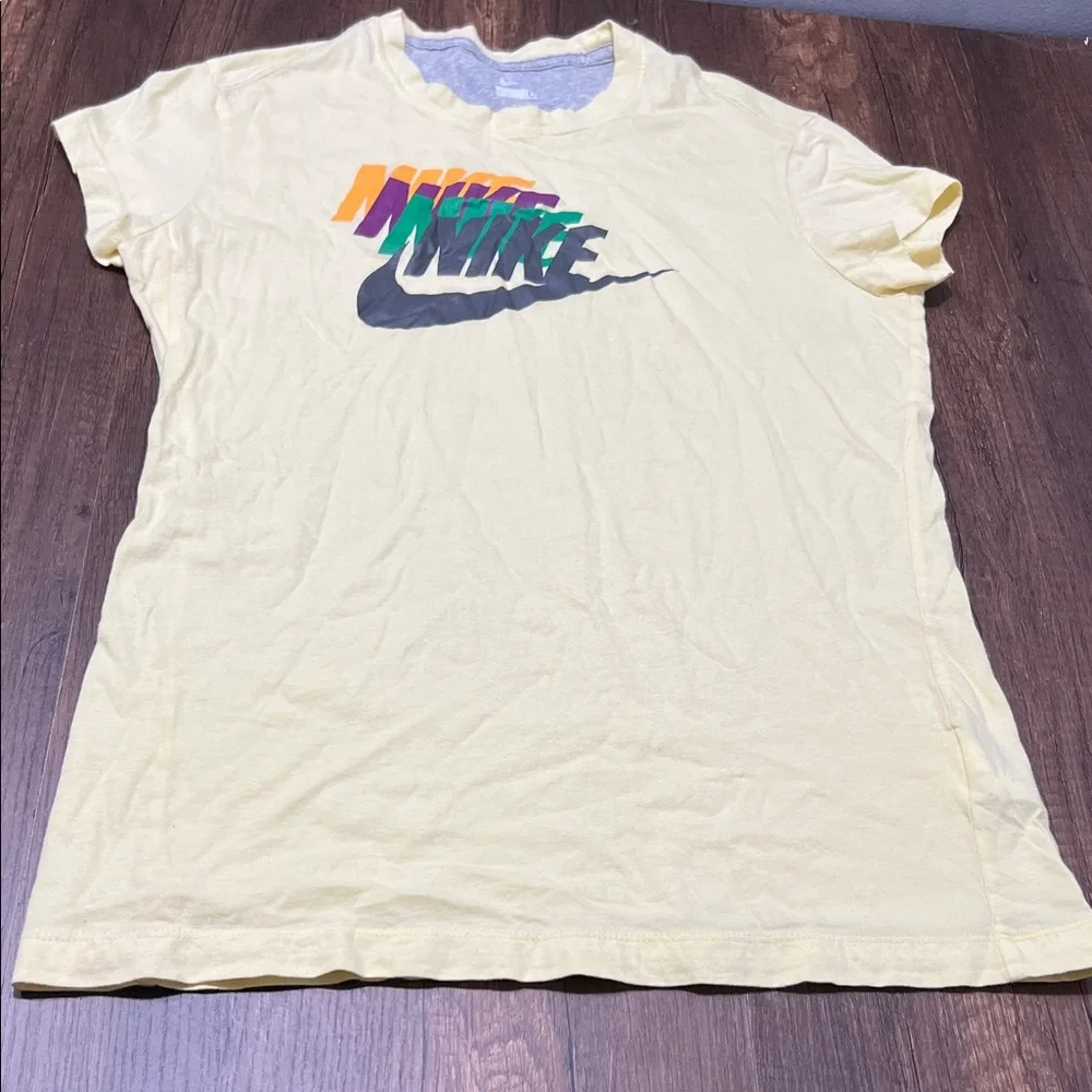 Nike Yellow Tee with Multicolor Logo. CAJA. # 1. D